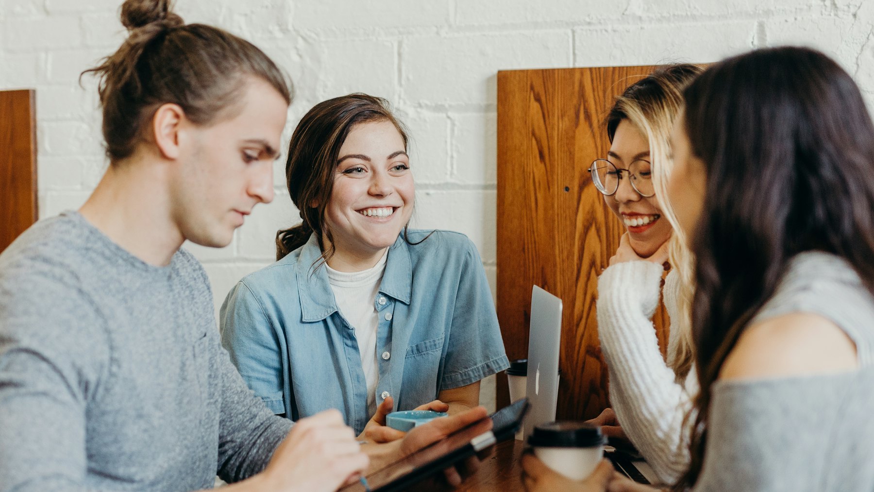 A group of friends together at a coffee shop
