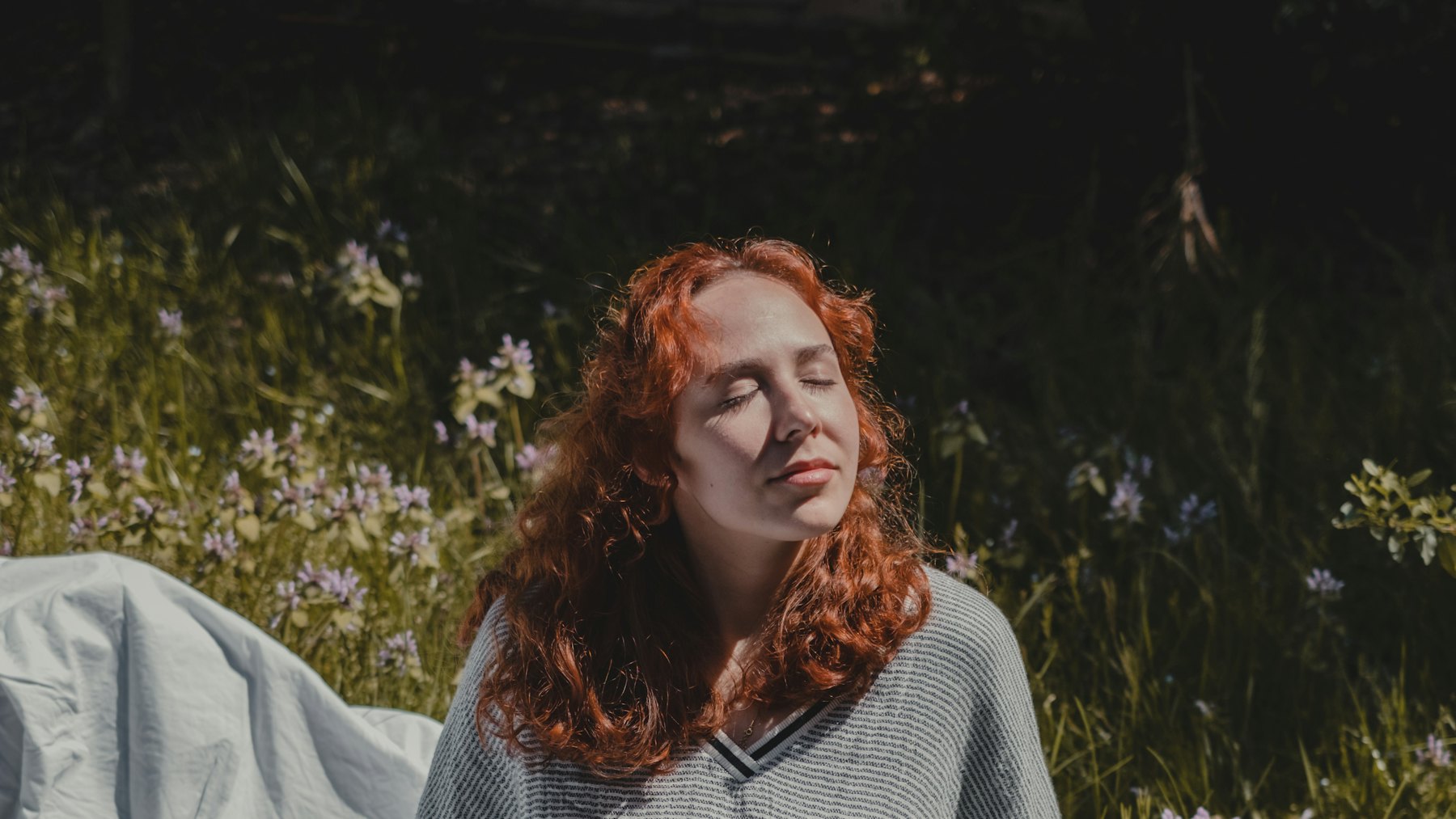 A woman sitting quietly with her eyes closed