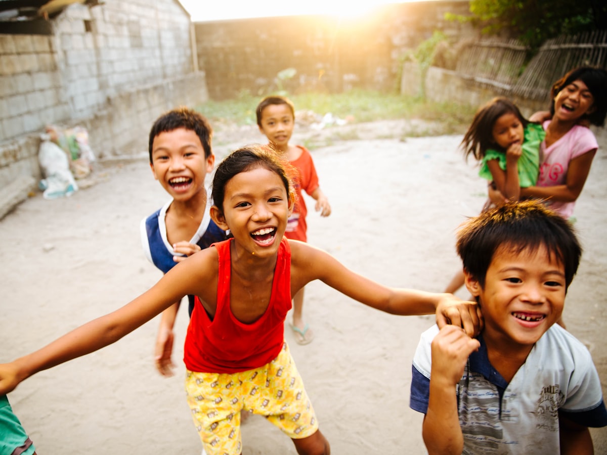A group of children laughing together — People
